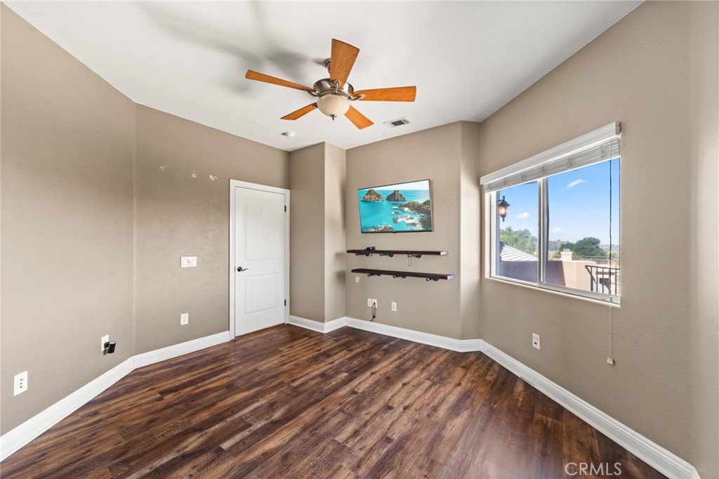 38136 Butterfly Court Yucaipa, CA 92399 - Photo 58 of 71 a view of a room with window ceiling fan and wooden floor