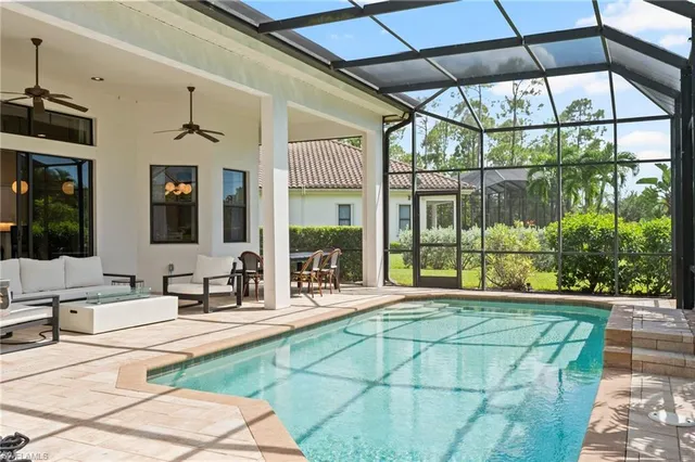 a room with pool table and windows