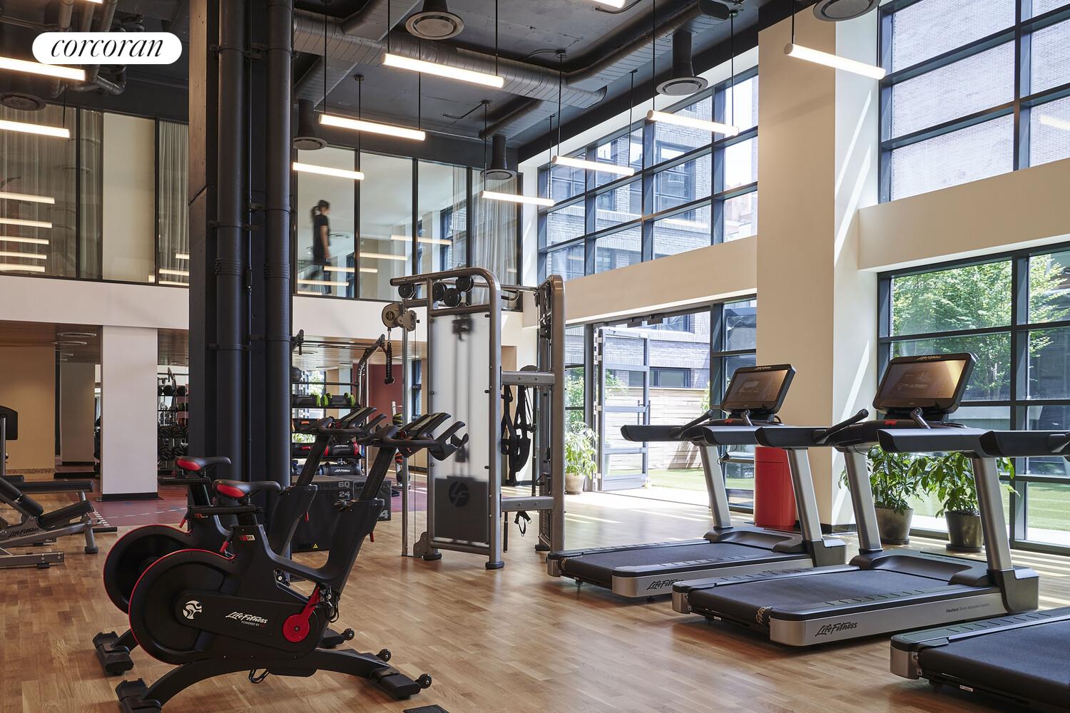 547 West 47th Street, Unit 405 Manhattan, NY 10036 - Photo 19 of 28 a room with gym equipment and large mirror