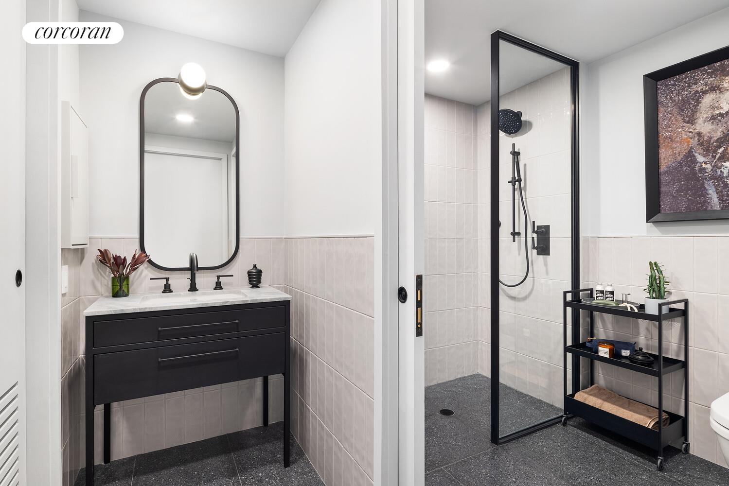 547 West 47th Street, Unit 405 Manhattan, NY 10036 - Photo 6 of 28 a bathroom with a sink a mirror and a shower