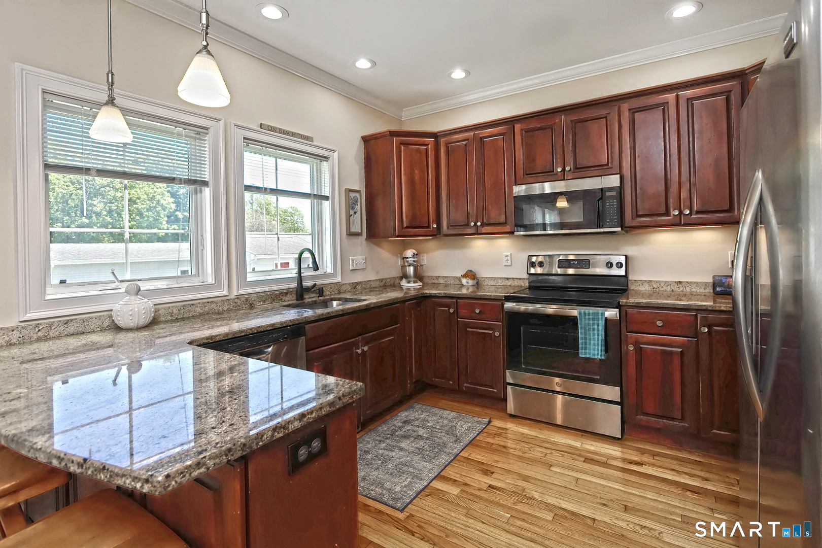 102 Lantern Court, Unit 102 Clinton, CT 06413 - Photo 18 of 36 a kitchen with stainless steel appliances granite countertop a stove a sink dishwasher a refrigerator and a microwave
