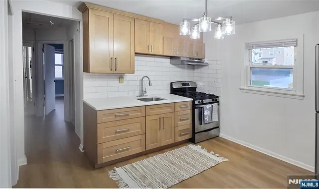 a kitchen with a sink cabinets and window
