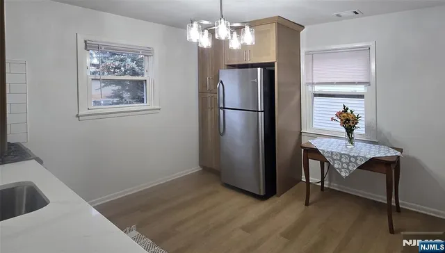 a view of a workspace with furniture and chandelier