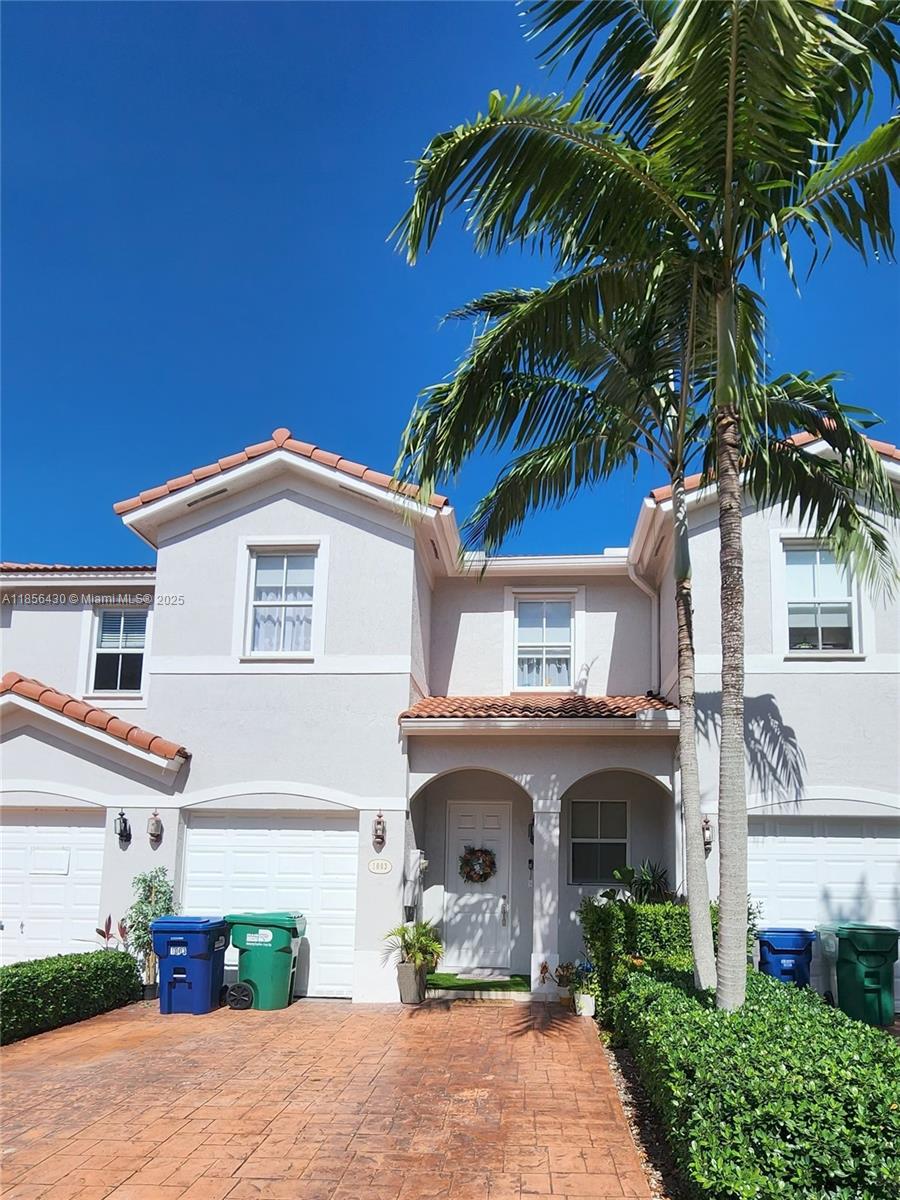 Ives Estates Miami, FL 33179 - Photo 1 of 28 a front view of a house with a yard and a garage