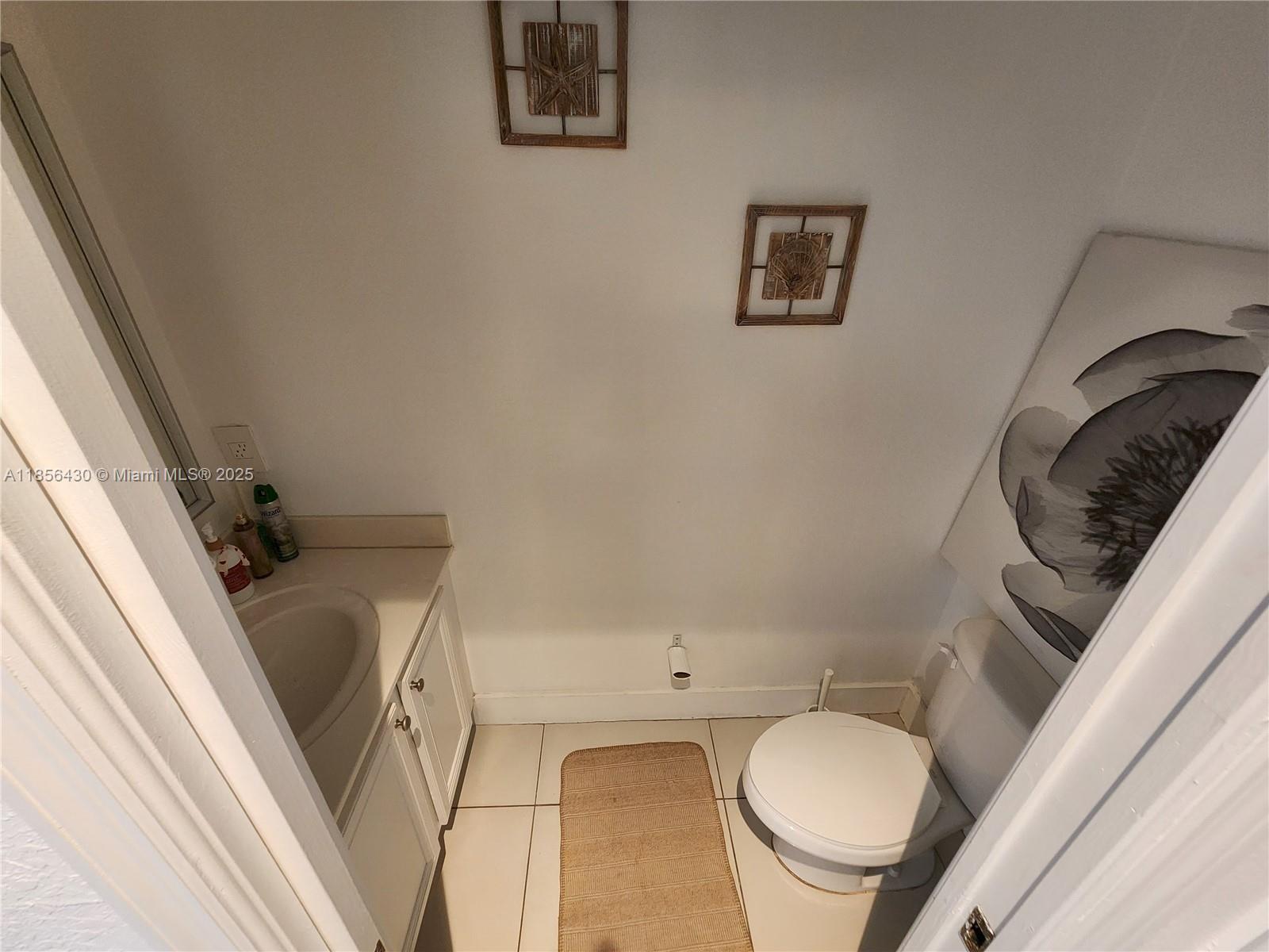 Ives Estates Miami, FL 33179 - Photo 18 of 28 a bathroom with a granite countertop sink and a mirror