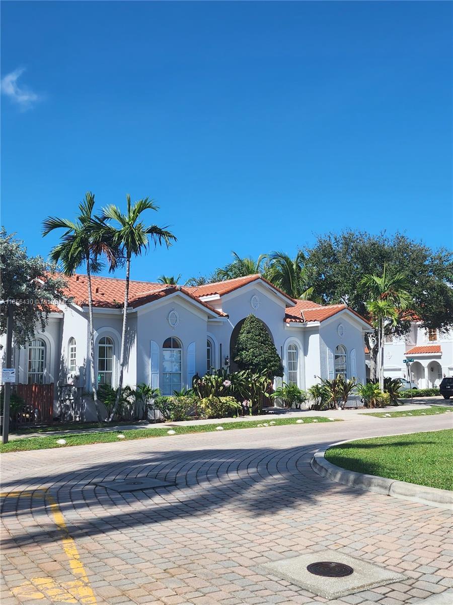 Ives Estates Miami, FL 33179 - Photo 23 of 28 front view of house with a yard and potted plants
