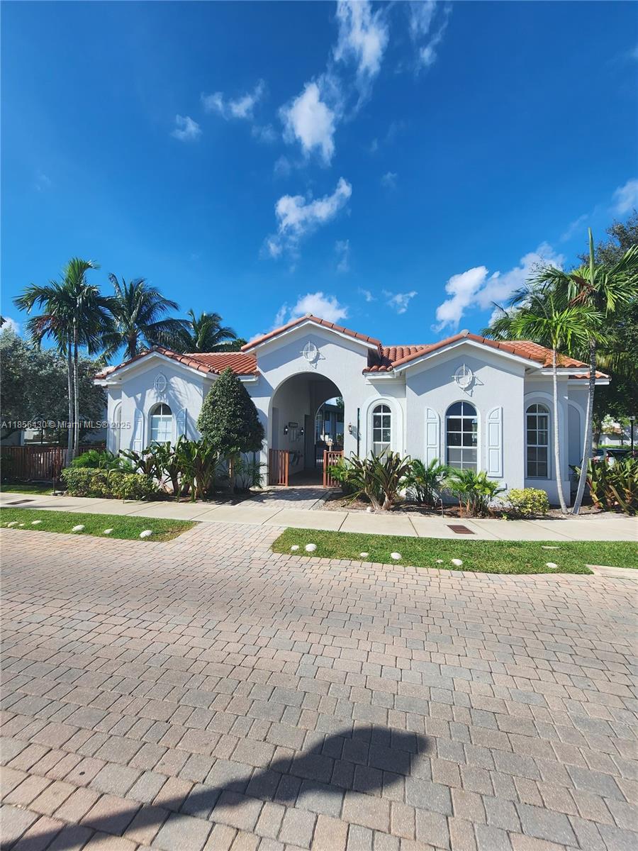 Ives Estates Miami, FL 33179 - Photo 24 of 28 a front view of a house with a yard and garage