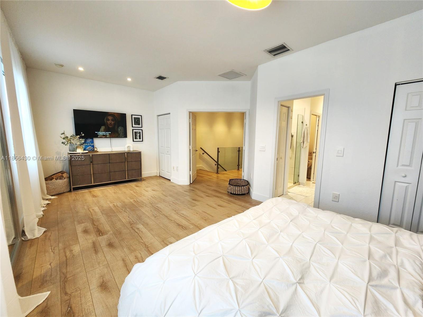 Ives Estates Miami, FL 33179 - Photo 10 of 28 a bedroom with a bed and flat screen tv