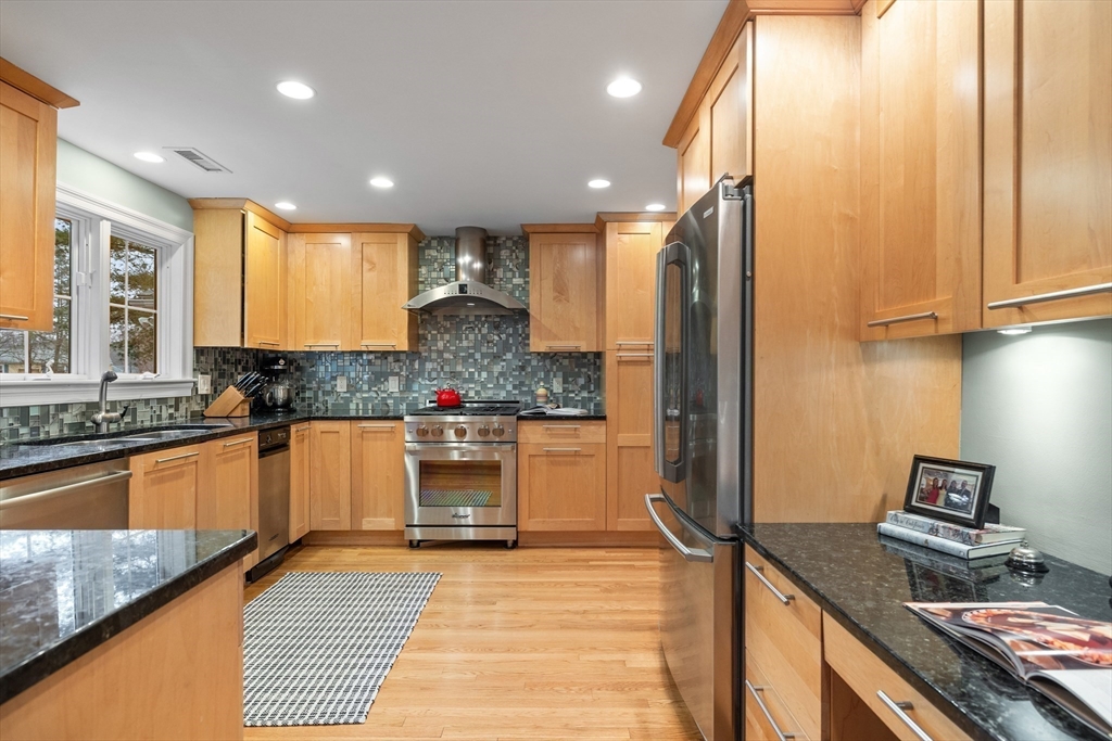 9 Augustus Road Lexington, MA 02421 - Photo 13 of 41 a kitchen with stainless steel appliances granite countertop a refrigerator and a stove