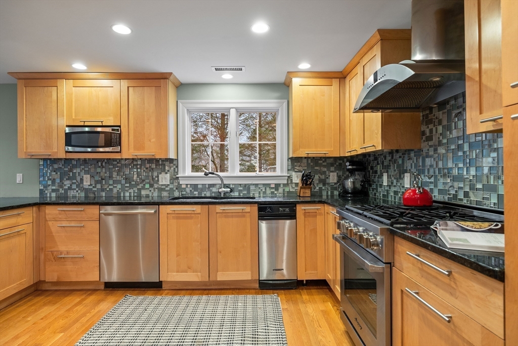 9 Augustus Road Lexington, MA 02421 - Photo 16 of 41 a kitchen with stainless steel appliances granite countertop a sink and a stove