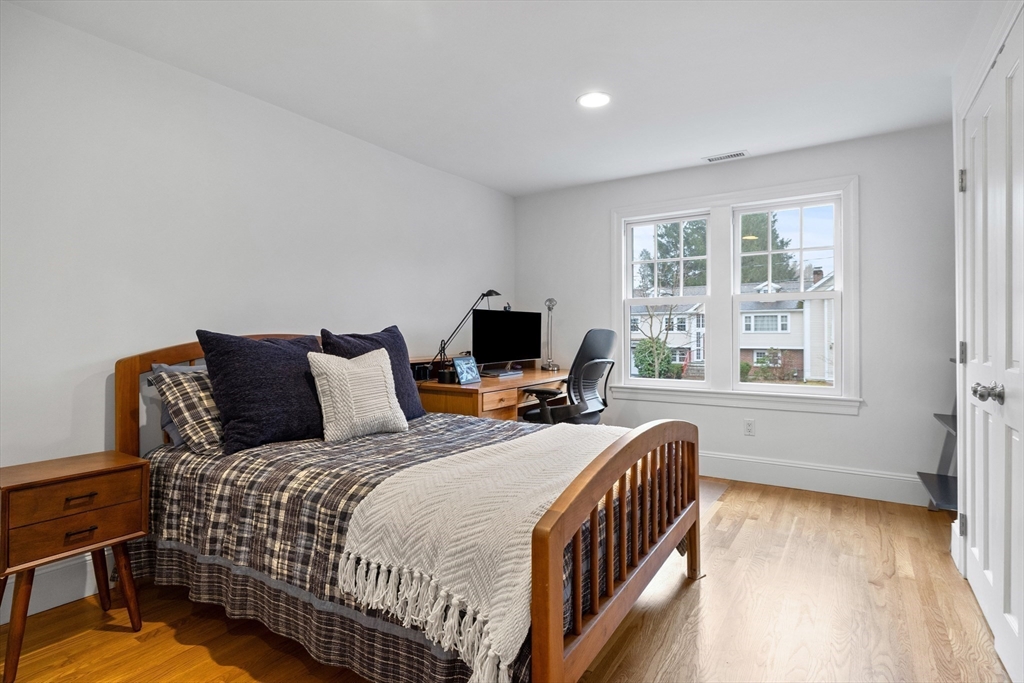 9 Augustus Road Lexington, MA 02421 - Photo 22 of 41 a bedroom with a bed and a flat screen tv