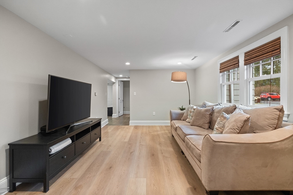 9 Augustus Road Lexington, MA 02421 - Photo 35 of 41 a living room with furniture and a flat screen tv