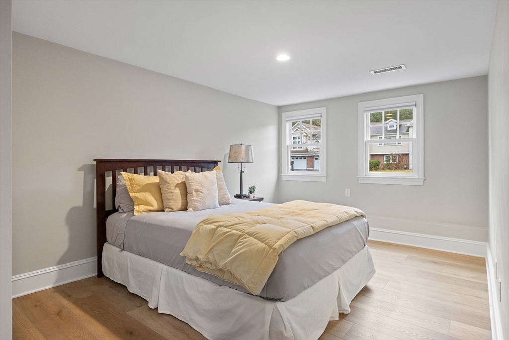 9 Augustus Road Lexington, MA 02421 - Photo 36 of 41 a bedroom with a large bed and a night stand