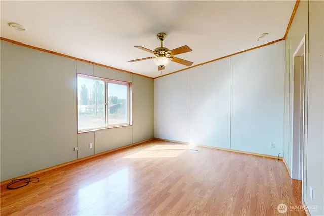 wooden floor in an empty room with a window