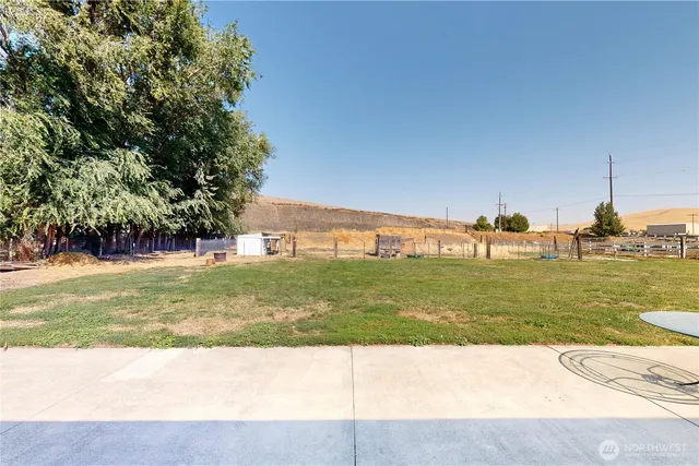 a view of a swimming pool with a yard