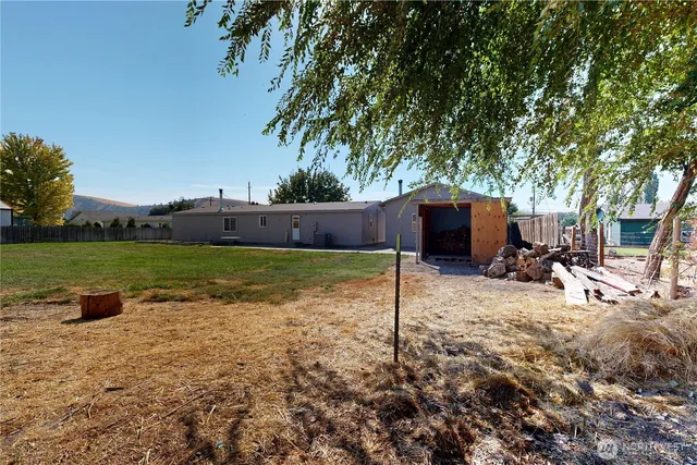 a view of house with yard and green space