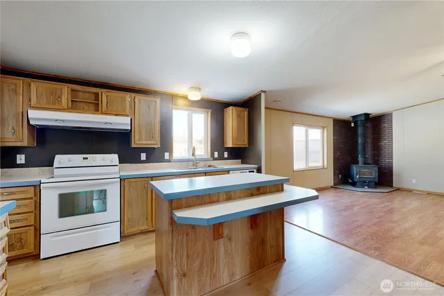 a kitchen that has a stove and a table in it