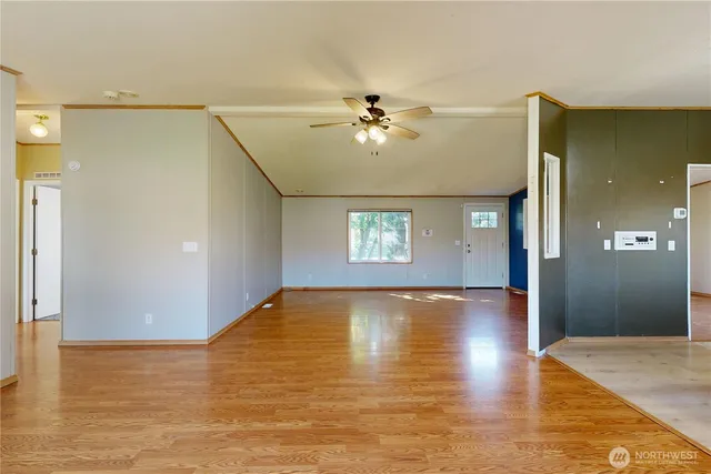 a view of empty room with wooden floor