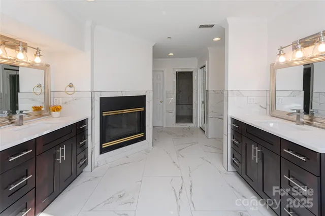 a spacious bathroom with a sink double vanity and a large mirror