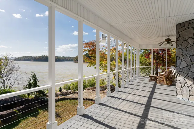 a balcony with wooden floor and glass door