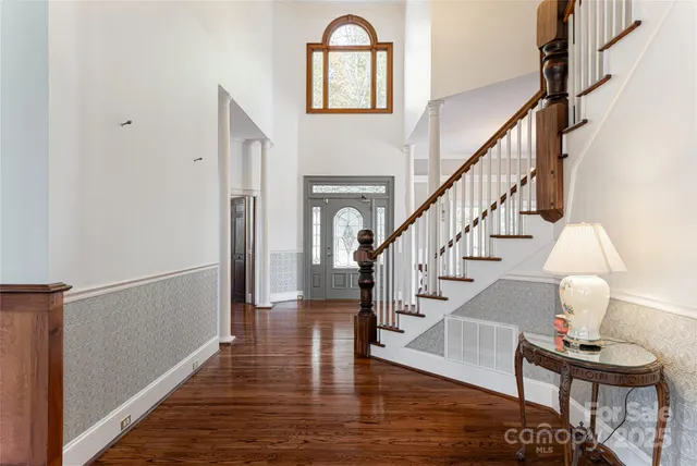 a view of entryway and hall with wooden floor