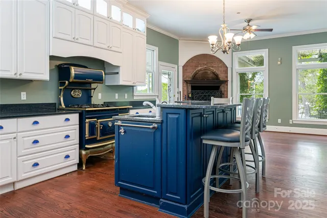 a kitchen with stainless steel appliances a stove a sink dishwasher and cabinets with wooden floor