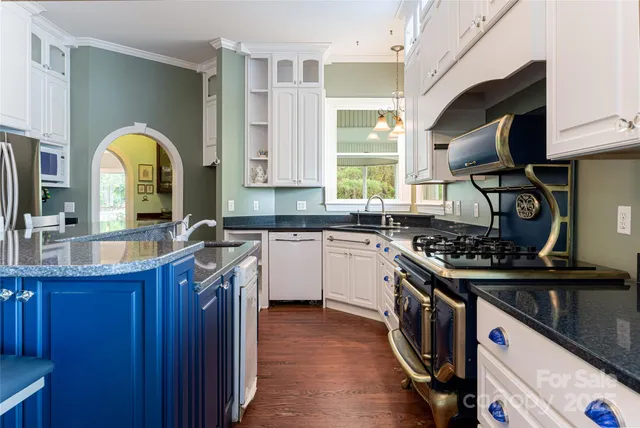a kitchen with a sink a stove and cabinets