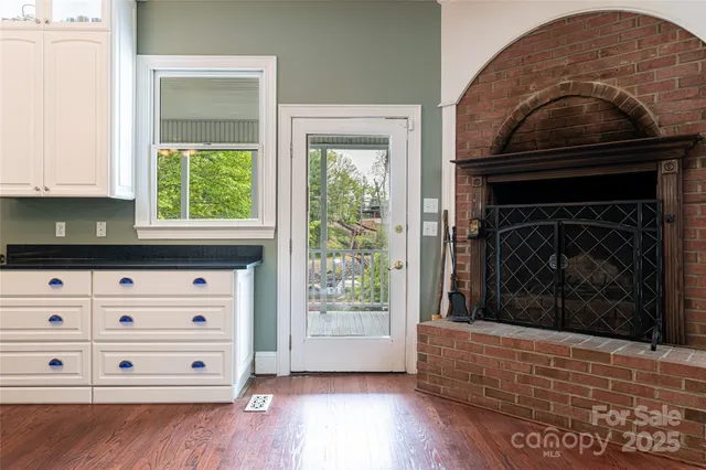 a kitchen with granite countertop a stove and a wooden floor