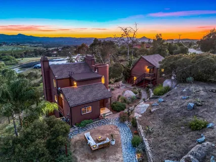 an aerial view of a house with mountain view