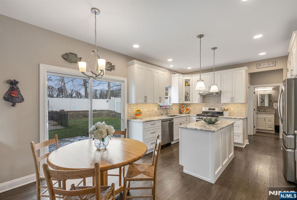 7 Winding Ridge Road Lake Hopatcong, NJ 07849 - Photo 13 of 48 a open kitchen with stainless steel appliances granite countertop a stove a refrigerator a kitchen island a table and chairs