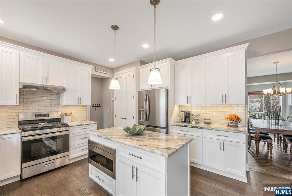 7 Winding Ridge Road Lake Hopatcong, NJ 07849 - Photo 15 of 48 a kitchen with a sink stove and cabinets