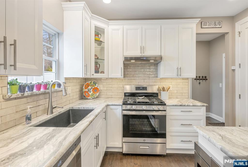7 Winding Ridge Road Lake Hopatcong, NJ 07849 - Photo 16 of 48 a kitchen with stainless steel appliances granite countertop a stove and white cabinets