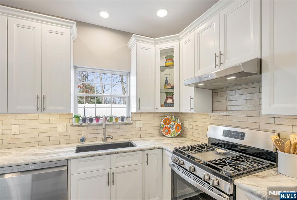 7 Winding Ridge Road Lake Hopatcong, NJ 07849 - Photo 17 of 48 a kitchen with stainless steel appliances granite countertop a sink stove and cabinets