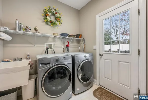 a utility room with dryer washer and a window