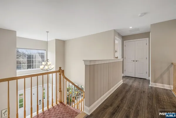 a view of hallway with wooden floor