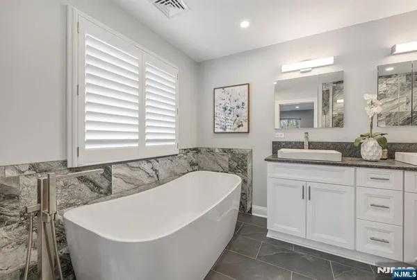 a bathroom with a bathtub and a sink