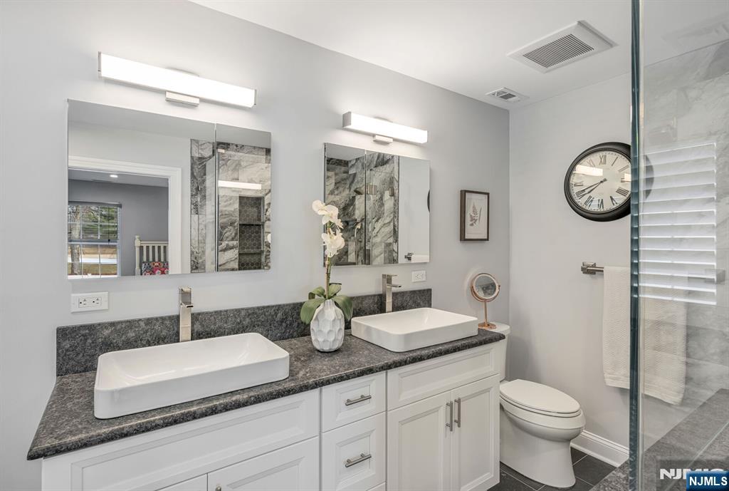 7 Winding Ridge Road Lake Hopatcong, NJ 07849 - Photo 29 of 48 a bathroom with a toilet a sink and mirror