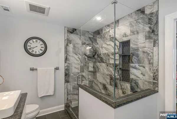 a bathroom with a shower toilet and a sink