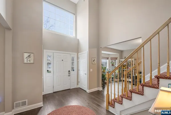 a view of entryway with wooden floor and stairs