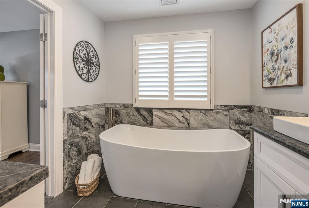 7 Winding Ridge Road Lake Hopatcong, NJ 07849 - Photo 31 of 48 a white bath tub sitting in a bathroom