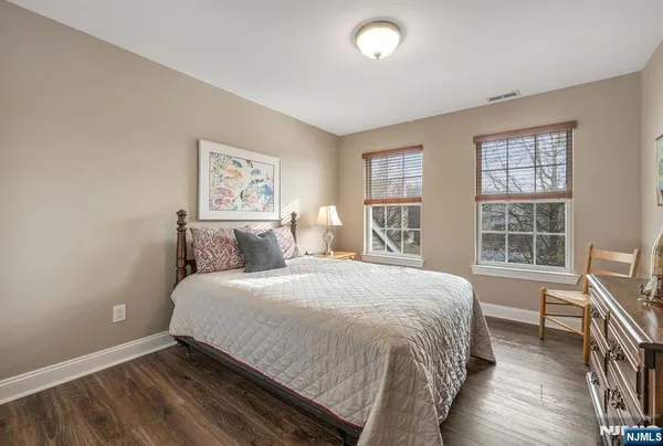 a large bed sitting in a bedroom next to a window