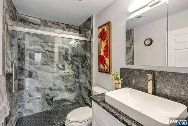a bathroom with a sink a toilet and shower curtain