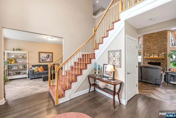 a view of entryway livingroom and hall with wooden floor