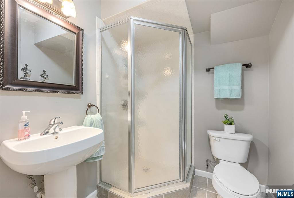 7 Winding Ridge Road Lake Hopatcong, NJ 07849 - Photo 43 of 48 a bathroom with a toilet a sink and mirror