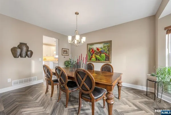 a view of a dining room with furniture and chandelier