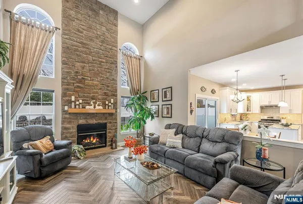 a living room with furniture fireplace and a large window