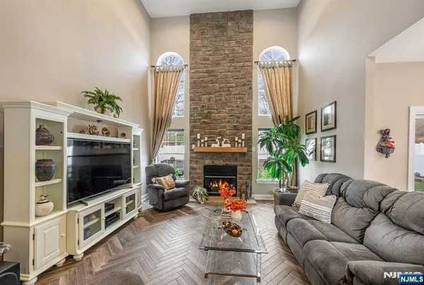 a living room with furniture a flat screen tv and a fireplace
