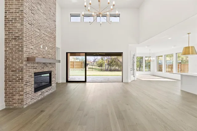 a view of an empty room with a fireplace and a window