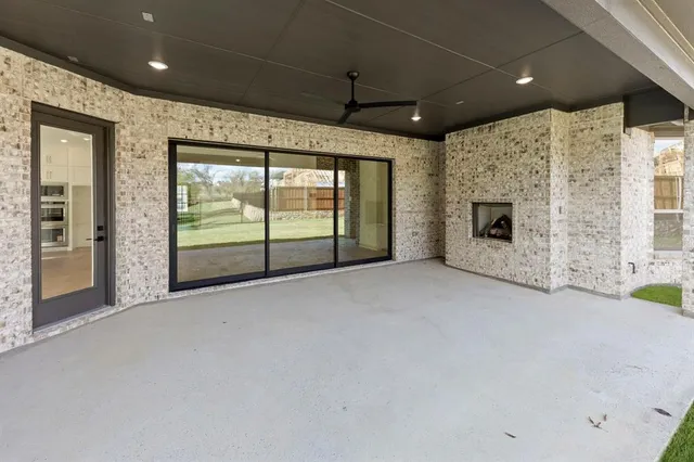 a view of a livingroom with a fireplace and window