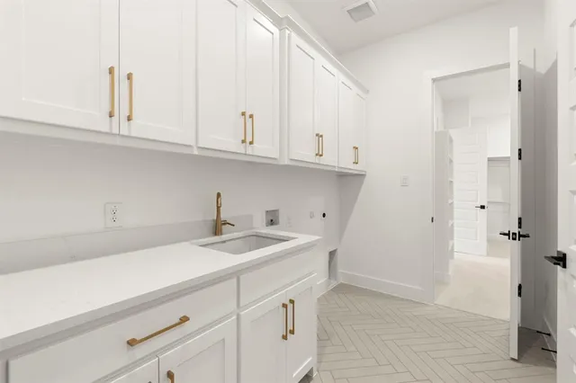 a kitchen with white cabinets and a sink